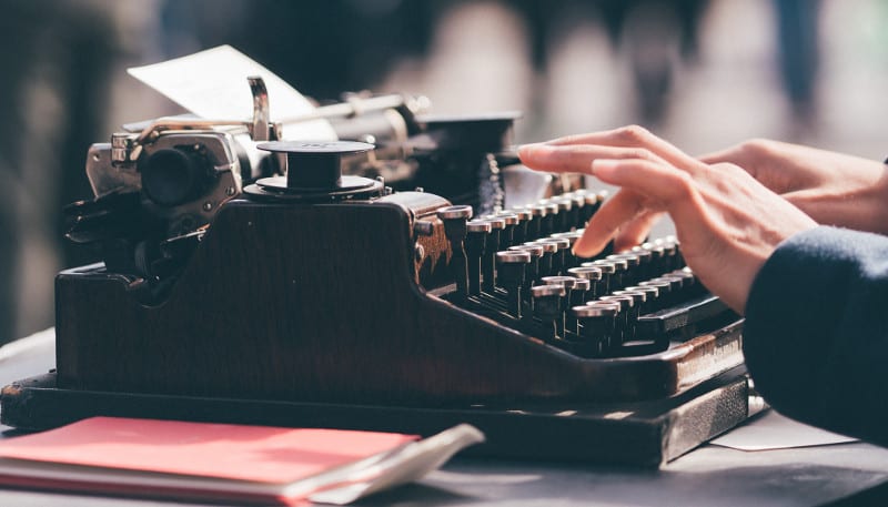 person-using-old-typewriter